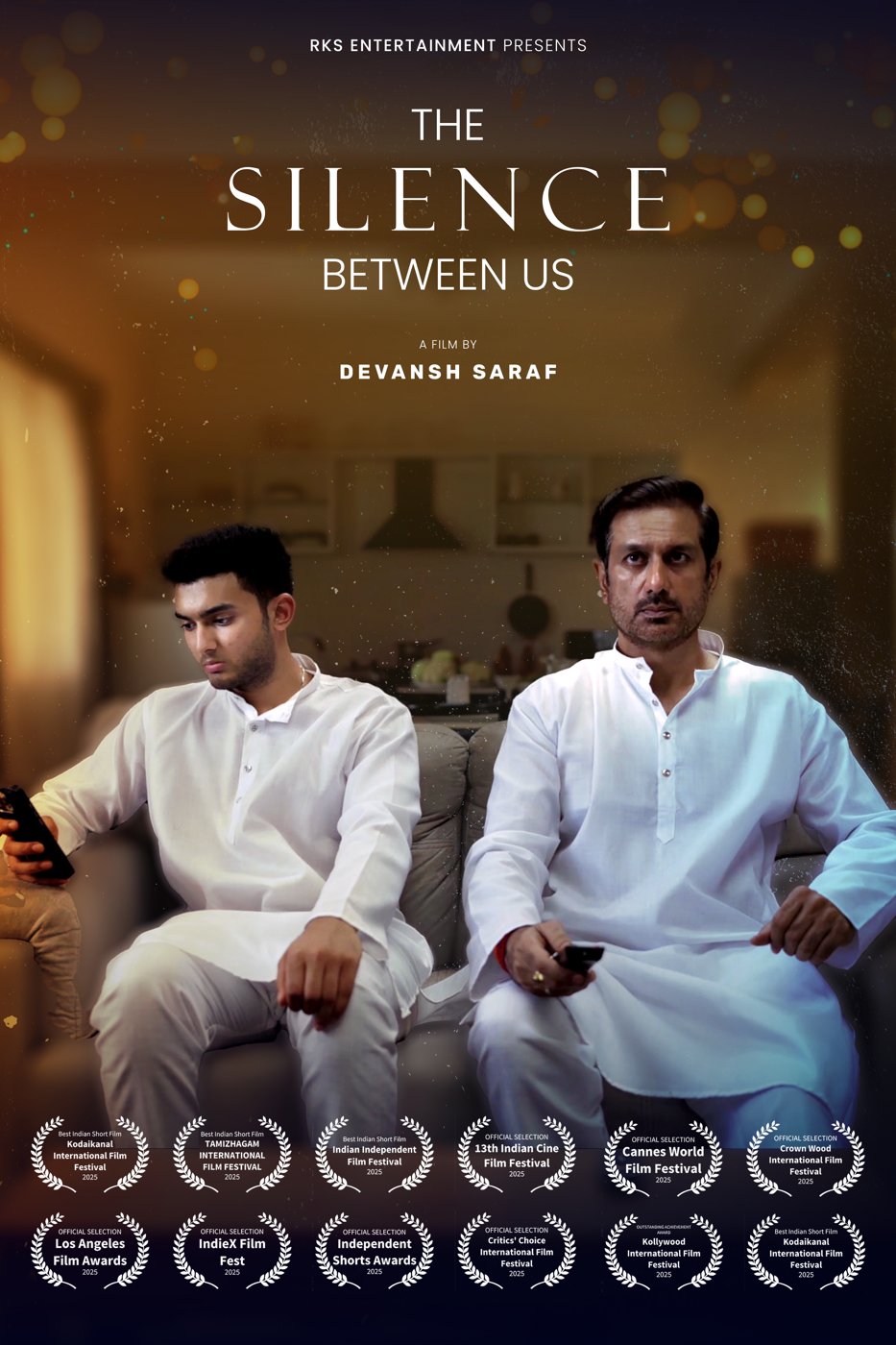 Poster for The Silence Between Us: a father and son in white kurtas sit apart on a sofa, each holding a phone
